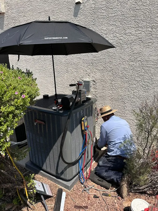 HVAC technician performing outdoor AC maintenance in Deerfield